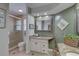 Elegant bathroom featuring granite countertops, white cabinets, a tiled shower, and tile flooring at 7600 Drew Oak Dr, Seminole, FL 33772