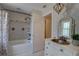 Bathroom featuring shower-over-tub and custom vanity at 7600 Drew Oak Dr, Seminole, FL 33772