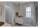 Bathroom with an antique white vanity and a window above at 7600 Drew Oak Dr, Seminole, FL 33772