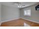 Empty bedroom showing hardwood floors, neutral decor, and a double window with abundant natural light at 7600 Drew Oak Dr, Seminole, FL 33772