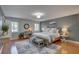 Comfortable bedroom features a well-lit interior, wood floors, a ceiling light, and tasteful decorations at 7600 Drew Oak Dr, Seminole, FL 33772