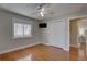 This bedroom has a ceiling fan, hardwood floors, and a mounted TV at 7600 Drew Oak Dr, Seminole, FL 33772