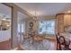 Inviting dining area featuring a glass table, wicker chairs, and views of the sparkling pool at 7600 Drew Oak Dr, Seminole, FL 33772