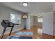 Exercise room with hardwood floors next to a bedroom at 7600 Drew Oak Dr, Seminole, FL 33772
