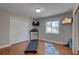 Exercise room with hardwood floors, and a 'Create the Body You Want' sign at 7600 Drew Oak Dr, Seminole, FL 33772