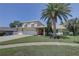 Charming two-story home featuring a well-manicured lawn, mature landscaping, and a spacious two-car garage at 7600 Drew Oak Dr, Seminole, FL 33772