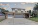Charming two-story home featuring a spacious driveway leading to an attached two-car garage at 7600 Drew Oak Dr, Seminole, FL 33772