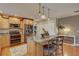 Bright kitchen featuring an island with seating, stainless appliances, hardwood floors, and wooden cabinetry at 7600 Drew Oak Dr, Seminole, FL 33772