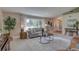 Comfortable living room with neutral tones, large window, stylish furniture, and ample natural light at 7600 Drew Oak Dr, Seminole, FL 33772
