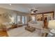 Bright living room featuring hardwood floors, comfortable seating, and seamless access to the outdoor pool area at 7600 Drew Oak Dr, Seminole, FL 33772