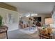 Inviting living room showcasing unique ceiling and large windows, with neutral carpet and comfortable seating at 7600 Drew Oak Dr, Seminole, FL 33772