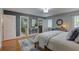 Serene main bedroom with hardwood floors, natural light, and a view into the main bathroom and walk-in closet at 7600 Drew Oak Dr, Seminole, FL 33772