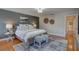 Cozy main bedroom with hardwood floors, a ceiling light, a sitting bench and neutral decor at 7600 Drew Oak Dr, Seminole, FL 33772