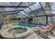 Enjoy a private outdoor oasis with a sparkling pool, spa, and screened enclosure for year-round fun at 7600 Drew Oak Dr, Seminole, FL 33772