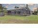 Enclosed back porch and backyard, featuring a screened-in pool area, perfect for outdoor relaxation and entertainment at 7600 Drew Oak Dr, Seminole, FL 33772
