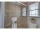 Bathroom featuring a walk-in shower, a built-in seat, and light tile at 7600 Drew Oak Dr, Seminole, FL 33772