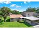 Aerial view of home with mature trees, grassy yard, and carport at 8630 Cattail Dr # 8630, Temple Terrace, FL 33637
