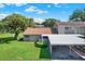 Aerial view of home featuring grassy yard, mature trees, and assigned parking at 8630 Cattail Dr # 8630, Temple Terrace, FL 33637