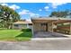 Charming single-story home featuring covered parking and manicured lawn at 8630 Cattail Dr # 8630, Temple Terrace, FL 33637
