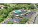 Aerial view of community clubhouse with mature landscaping and ample parking at 9735 Conservation Dr, New Port Richey, FL 34655