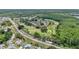 Sprawling aerial view showcasing homes situated along the golf course and tree-lined streets at 9735 Conservation Dr, New Port Richey, FL 34655