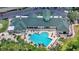 An aerial view of community clubhouse with an inviting pool and patio area, perfect for relaxation at 9735 Conservation Dr, New Port Richey, FL 34655