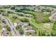 Beautiful aerial view of homes bordering the golf course, natural areas, and water features at 9735 Conservation Dr, New Port Richey, FL 34655