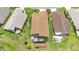 An aerial view shows a home with a screen enclosed patio, set in a residential neighborhood at 9735 Conservation Dr, New Port Richey, FL 34655