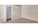 Neutral bedroom featuring carpet and a closet with built-in shelving for ample storage at 9735 Conservation Dr, New Port Richey, FL 34655
