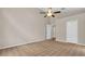 Neutral bedroom features patterned carpet and a closet with bifold doors at 9735 Conservation Dr, New Port Richey, FL 34655