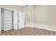 Neutral bedroom featuring carpet, a closet with built-in shelving, and an interior door at 9735 Conservation Dr, New Port Richey, FL 34655