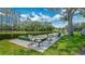 Well-maintained bocce ball court with seating, surrounded by lush landscaping and greenery at 9735 Conservation Dr, New Port Richey, FL 34655