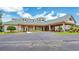 Exterior shot of the clubhouse, showcasing its elegant design and covered entrance at 9735 Conservation Dr, New Port Richey, FL 34655