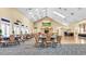 Spacious ballroom featuring high ceilings, neutral colors, and elegant tables and chairs for large events at 9735 Conservation Dr, New Port Richey, FL 34655