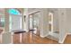 Bright foyer boasts sleek hardwood floors, complemented by large arched windows and a mirrored closet at 9735 Conservation Dr, New Port Richey, FL 34655
