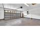 Spacious two car garage featuring a large door, shelving, and plenty of room for parking and storage at 9735 Conservation Dr, New Port Richey, FL 34655