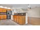 Kitchen with stainless steel appliances, dark granite countertops, wooden cabinets and an eat-in counter at 9735 Conservation Dr, New Port Richey, FL 34655