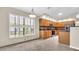 Modern kitchen with tile floors, wood cabinets, stainless steel appliances, and natural light at 9735 Conservation Dr, New Port Richey, FL 34655