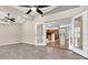 Living room features tiled floors and glass doors to connect indoor and outdoor spaces at 9735 Conservation Dr, New Port Richey, FL 34655