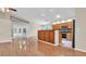 Bright living room with hardwood floors connected to an eat-in kitchen with stainless steel appliances at 9735 Conservation Dr, New Port Richey, FL 34655