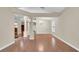 Spacious living room with hardwood floors, decorative columns, and a chandelier at 9735 Conservation Dr, New Port Richey, FL 34655