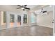 Bright living room with tiled floor and doors leading to the outside at 9735 Conservation Dr, New Port Richey, FL 34655