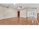 Open living room with hardwood floors, built-in shelving, and French doors to the outdoor area at 9735 Conservation Dr, New Port Richey, FL 34655