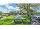 Outdoor shuffleboard court with shade, surrounded by lush green grass, perfect for recreational fun at 9735 Conservation Dr, New Port Richey, FL 34655