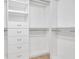Spacious walk-in closet with custom shelving and plenty of storage space at 9735 Conservation Dr, New Port Richey, FL 34655