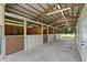 Interior of a barn featuring horse stalls and a wooden ceiling at 9780 Allen Rd, Lithia, FL 33547