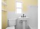 Clean bathroom with a pedestal sink and classic tiled walls at 9780 Allen Rd, Lithia, FL 33547
