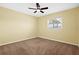 Bright bedroom featuring a ceiling fan and plush carpeting at 9780 Allen Rd, Lithia, FL 33547