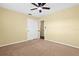 Neutral carpeted bedroom featuring a ceiling fan, with a calming and comfortable ambiance at 9780 Allen Rd, Lithia, FL 33547