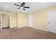 Neutral carpeted bedroom featuring a ceiling fan, with a calming and comfortable ambiance at 9780 Allen Rd, Lithia, FL 33547